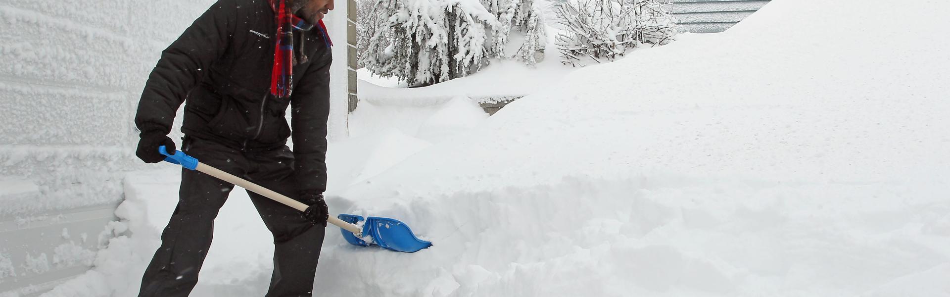 Man shoveling snow from driveway