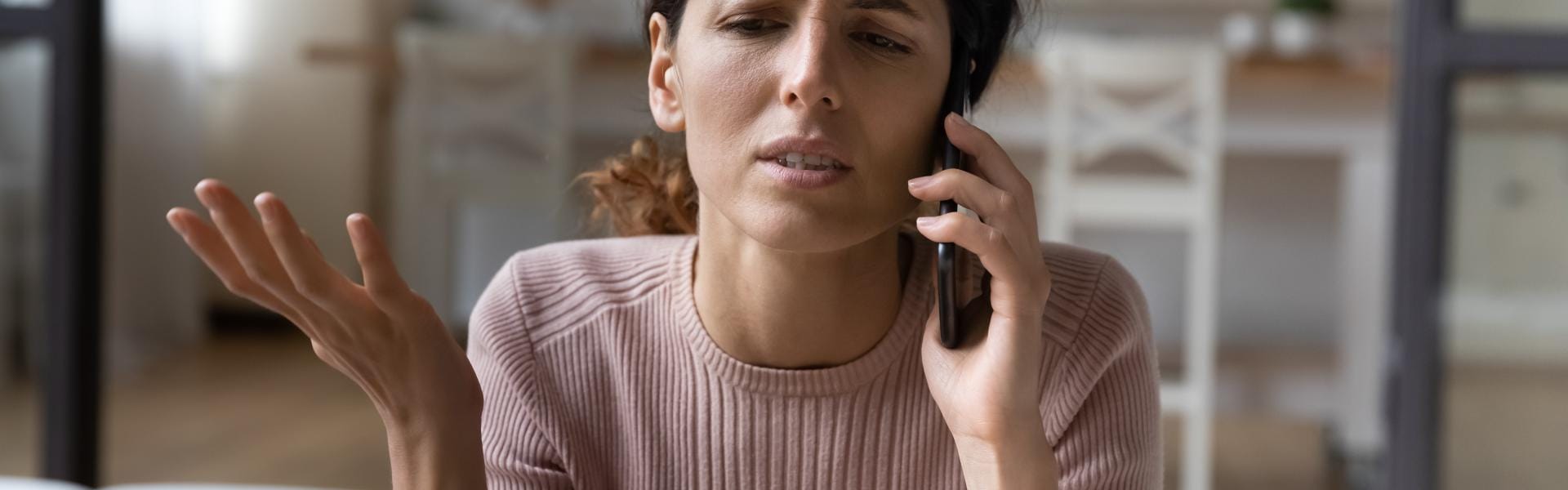 Women with concerned expression on cell phone