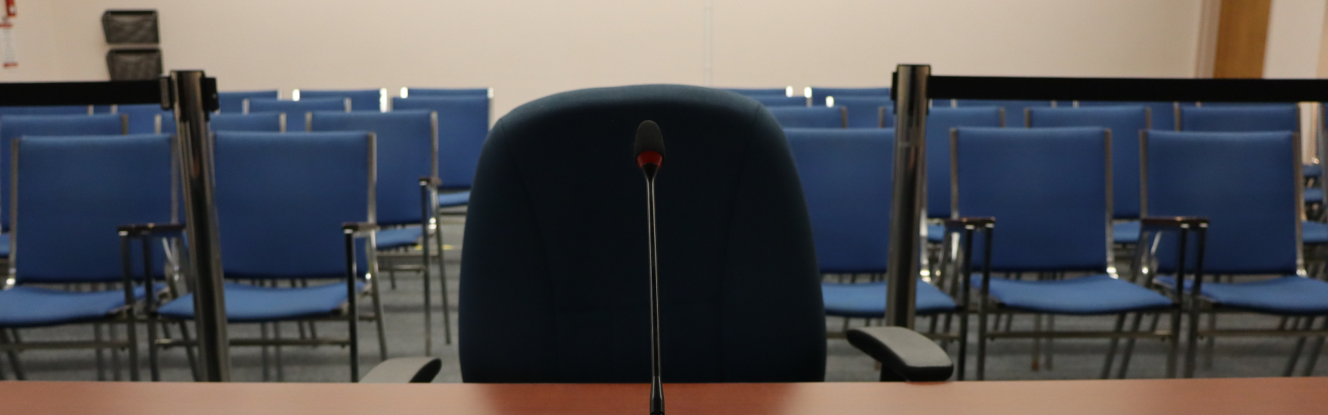 Banner version of the deputation microphone and chair and the audience chairs in council chambers