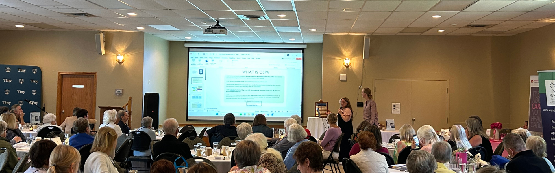 A large group of seniors watching a presentation.