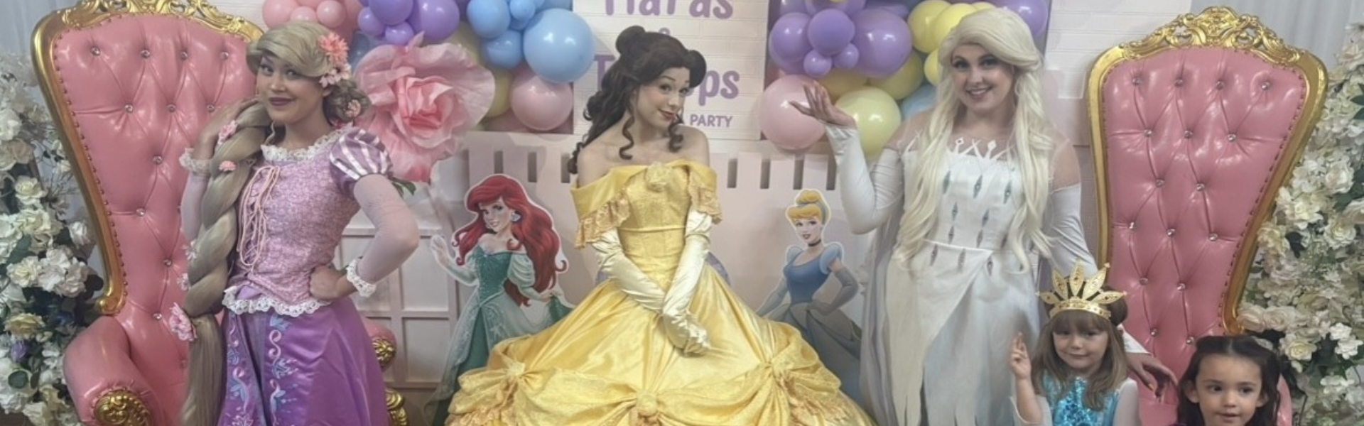 Three princesses posing for a photo.