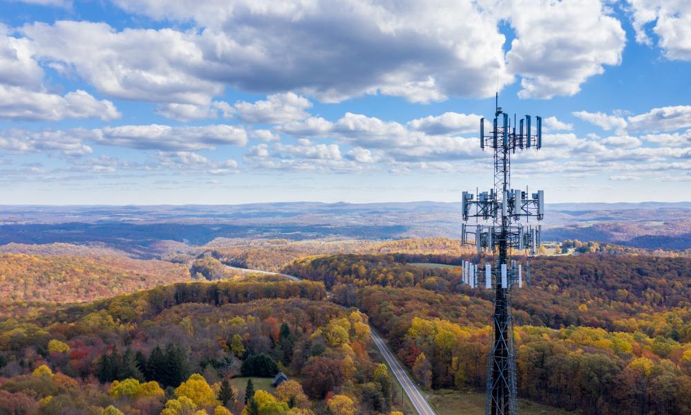 Aerial view of mobile phone cell tower over forested rural area