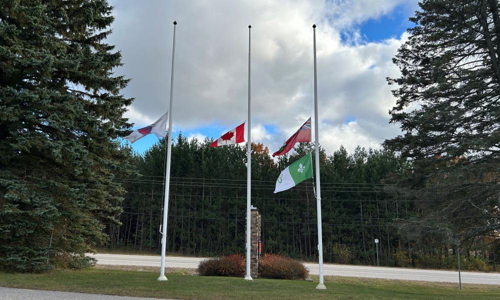 image of the flags at the Township of Tiny municipal office lowered to half-mast