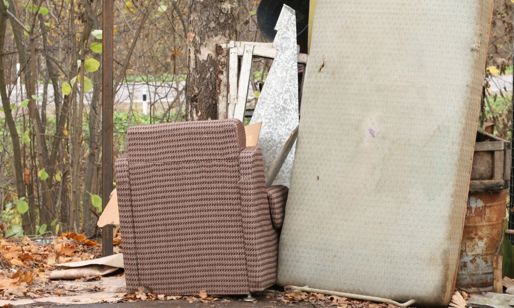 roadside debris such as broken chair, mattress, and scrap metal