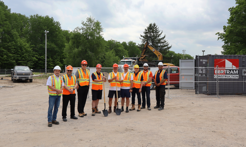 Members of Council, staff, and representatives from Bertram Construction pose for a photo in front of construction of the new Toanche Pavilion in Toanche Park