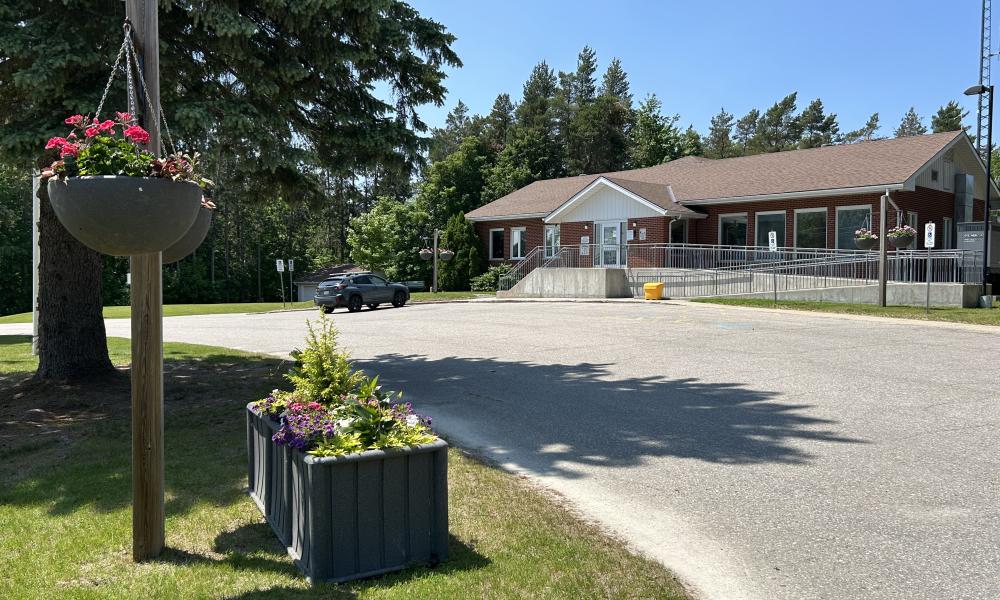 View of the Township of Tiny Office in the distance, showing the driveway and planters in the forefront