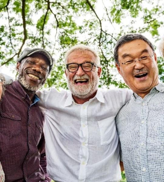 several seniors standing next to one another, with arms wrapped around one another's shoulders