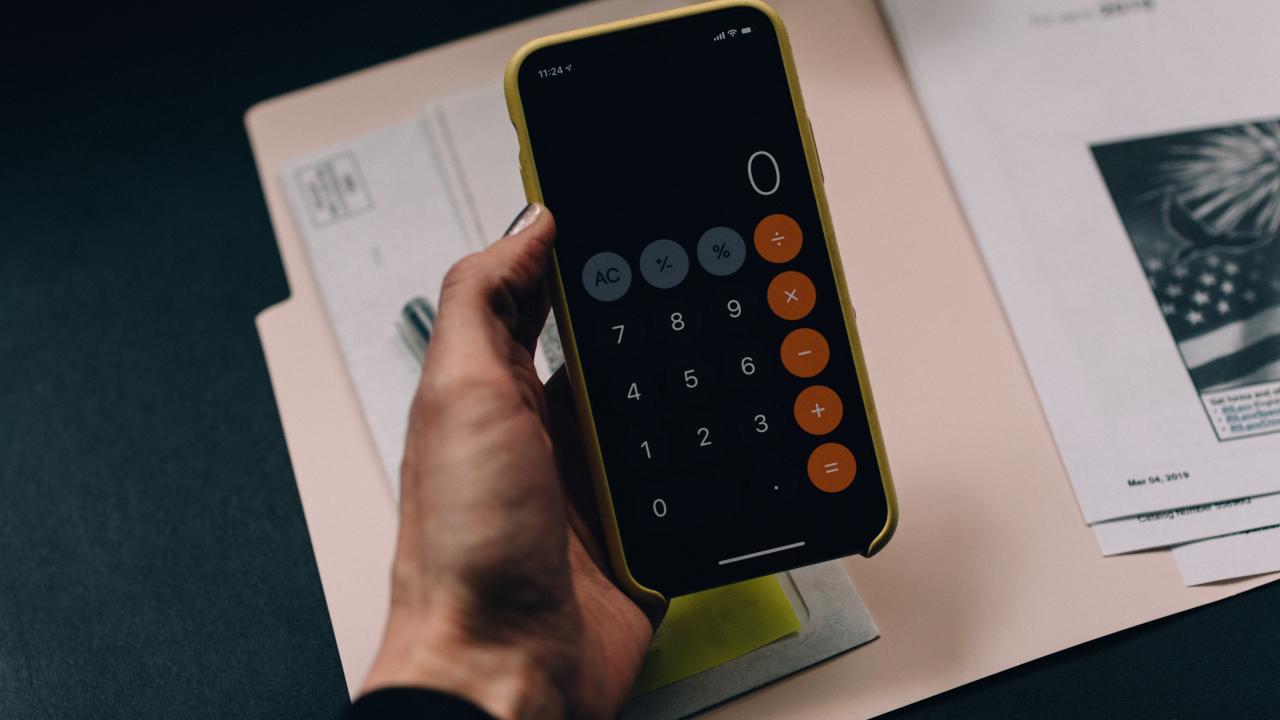 Person holding their phone using a the calculator application
