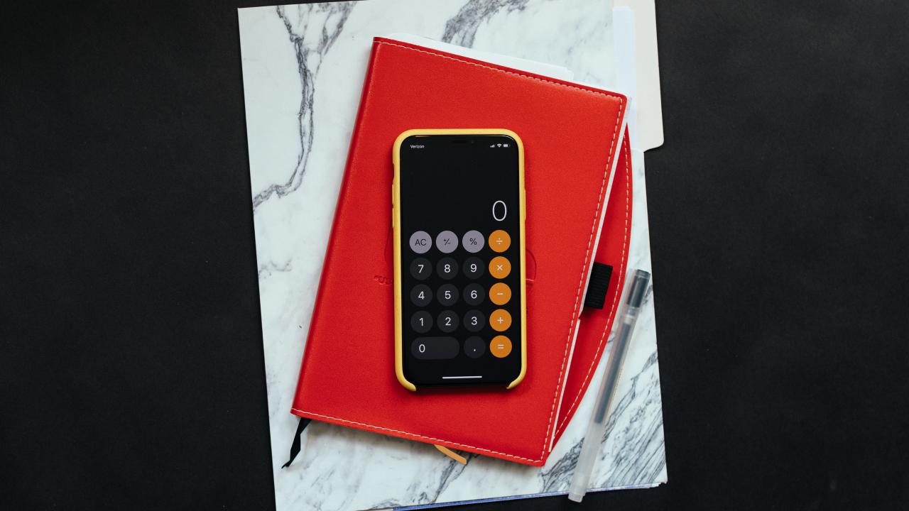 Photo of calculator on top of a notebook