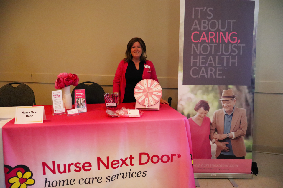 Nurse Next Door booth and staff representative