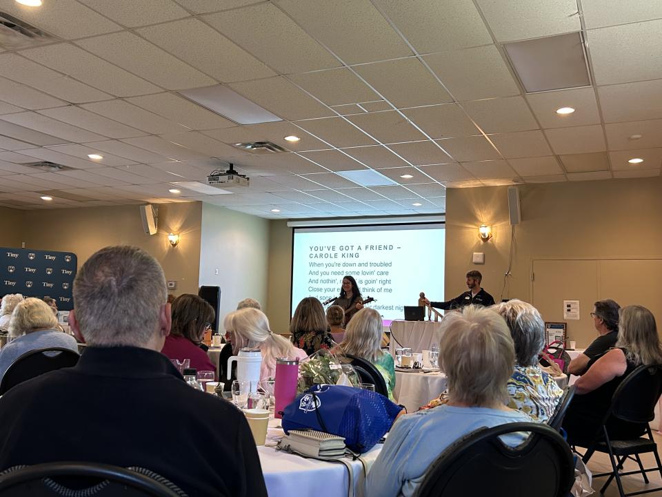 Crowd at the Senior Symposium listening to a music therapy session