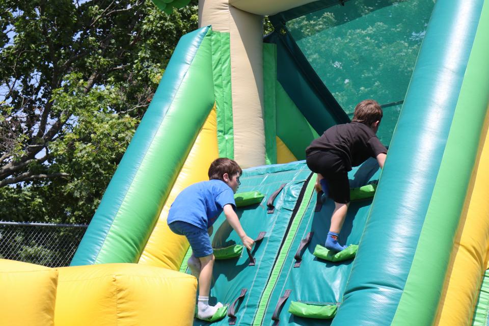 brothers climbing the ladders on the inflatable