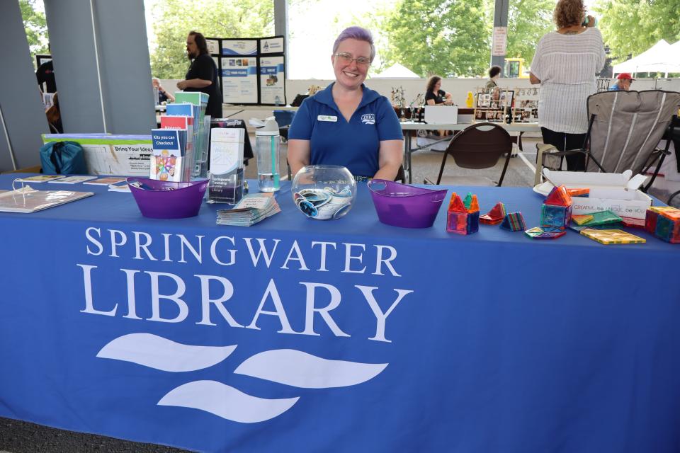 springwater public library staff at their booth under the pavillion