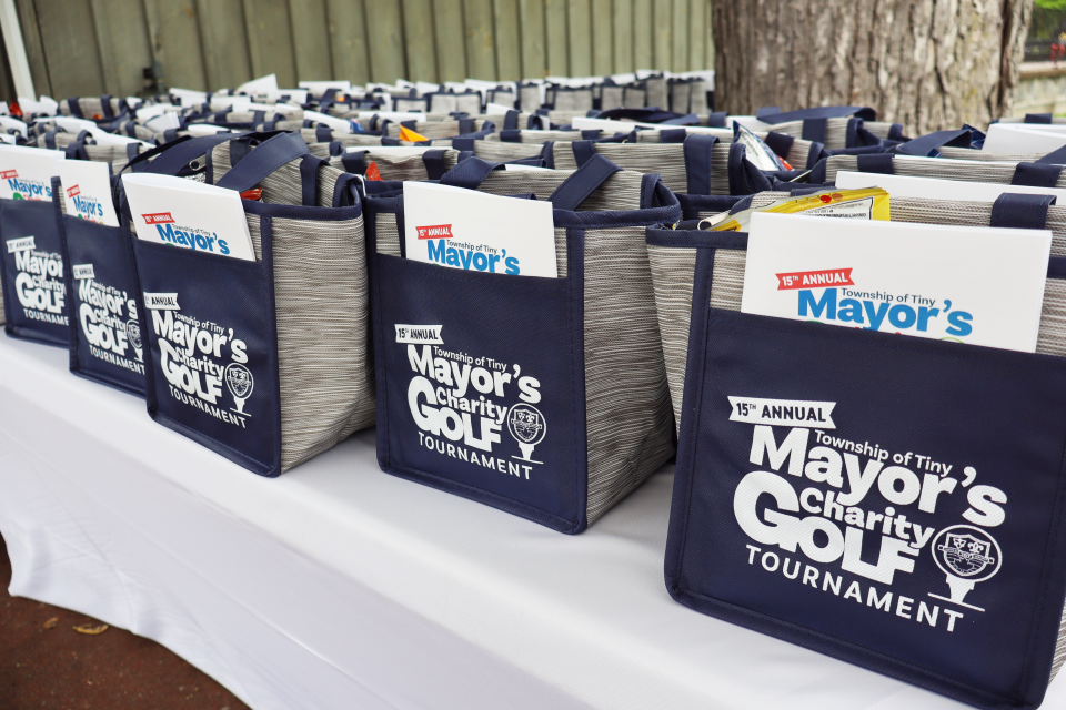 table of mayor's charity golf tournament branded lunchbags