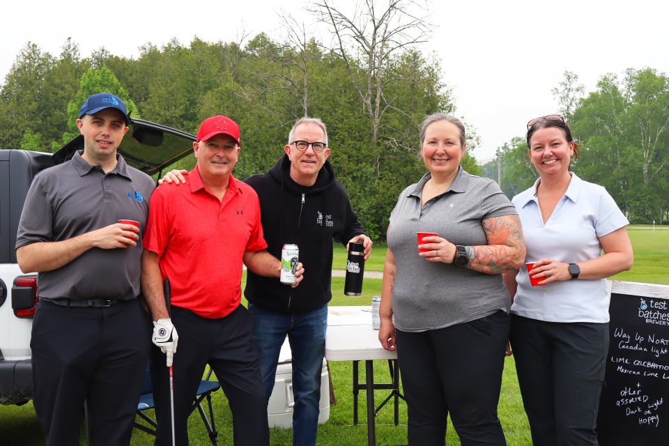 Golf foursome visiting the Test Batches Brewery sponsored hole.