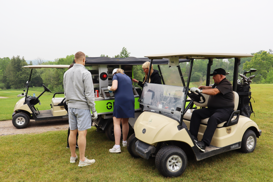 Golf participants pulling up to the GIP sponsored snack cart.
