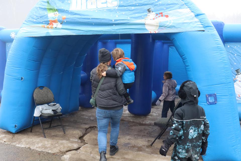 Family entering a large blue maze