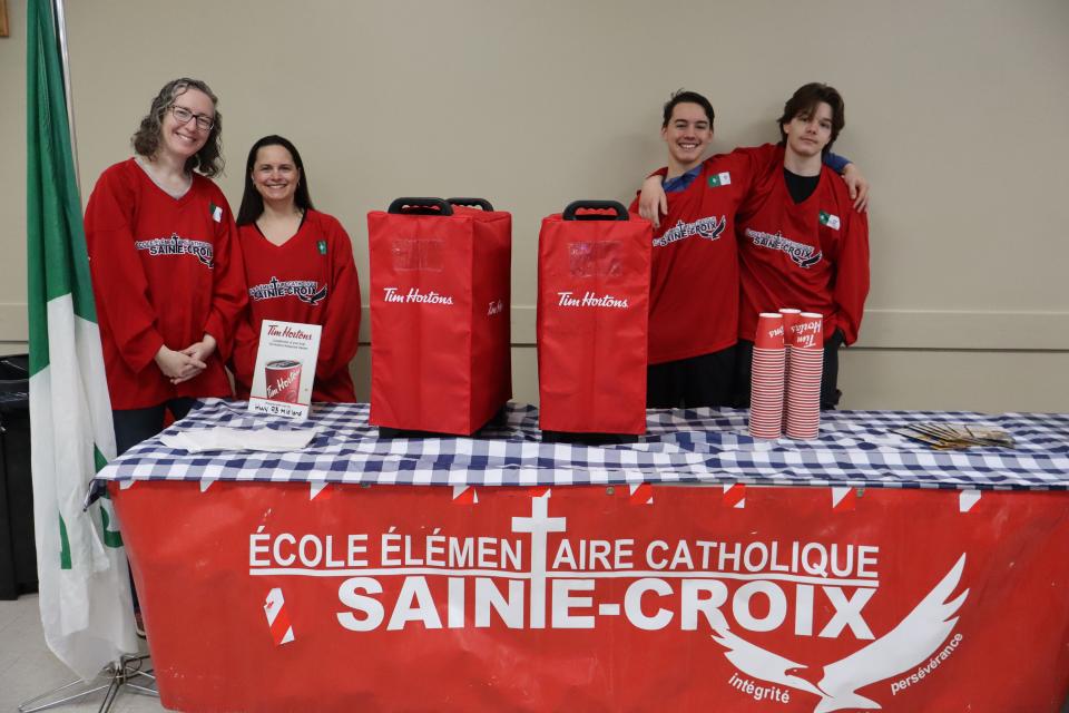 Volunteers dressed in Sainte Croix attire at the Tim Horton's hot chocolate station