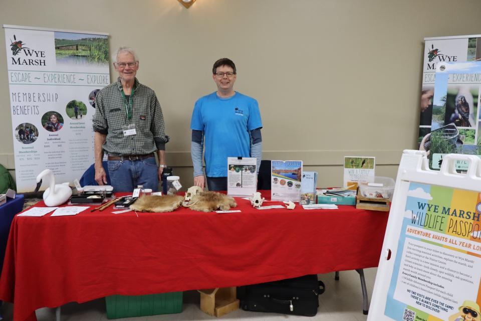 Representatives from Wye Marsh at their booth featuring various animal pelts and activities