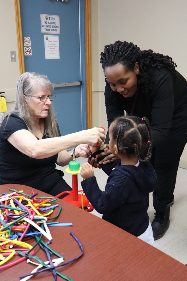 Mom and daughter getting a balloon animal from the balloon twister