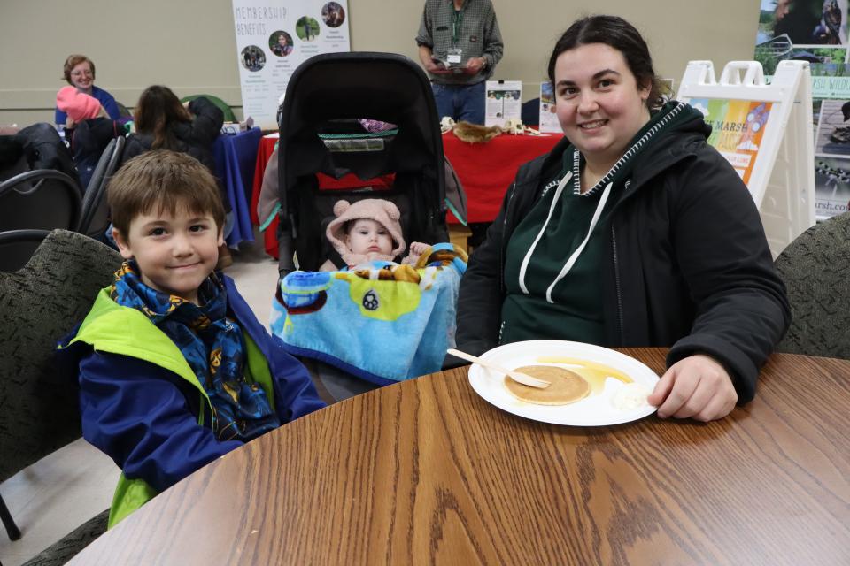Mom and two children, one in a stroller enjoying pancake lunch