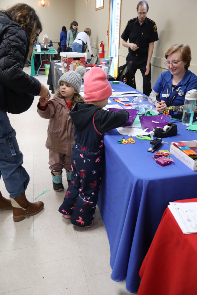 Young family interacting with staff from Springwater Public Library