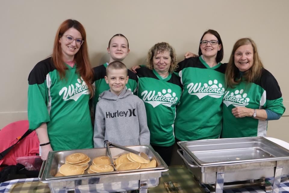 Volunteers dressed primarily in green Wyevale Wildcats jerseys