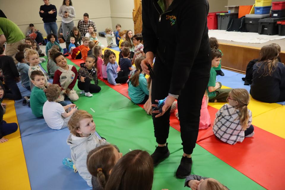 Zoo to You staff showing children a scorpion 