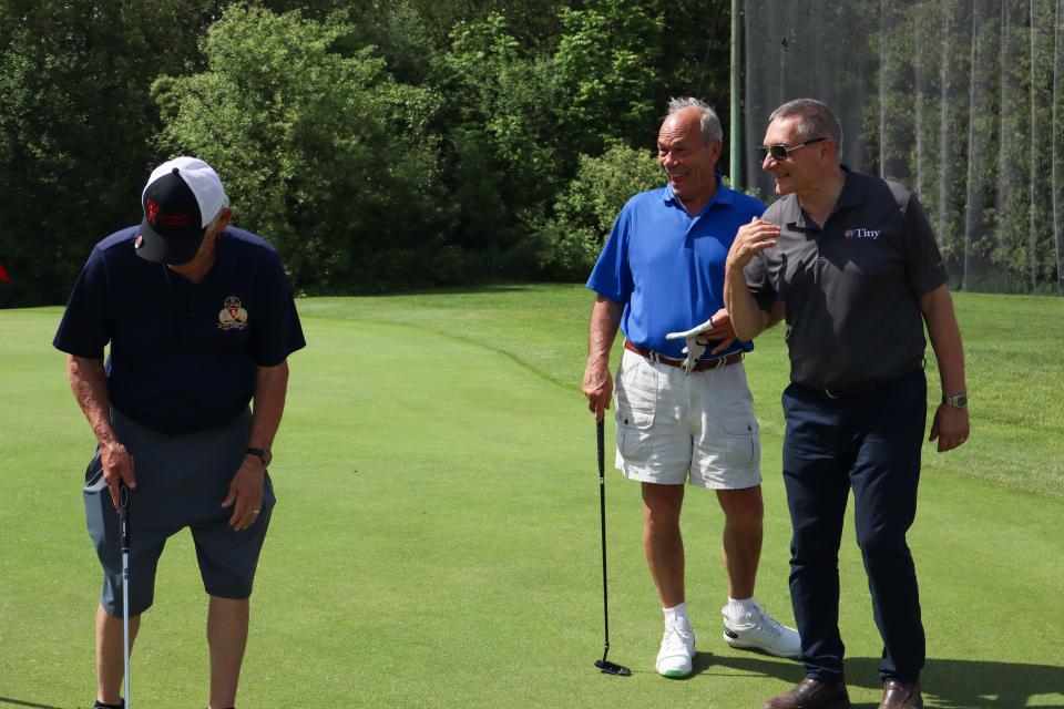 Three men in the putting green, including Councillor Dave Brunelle ​