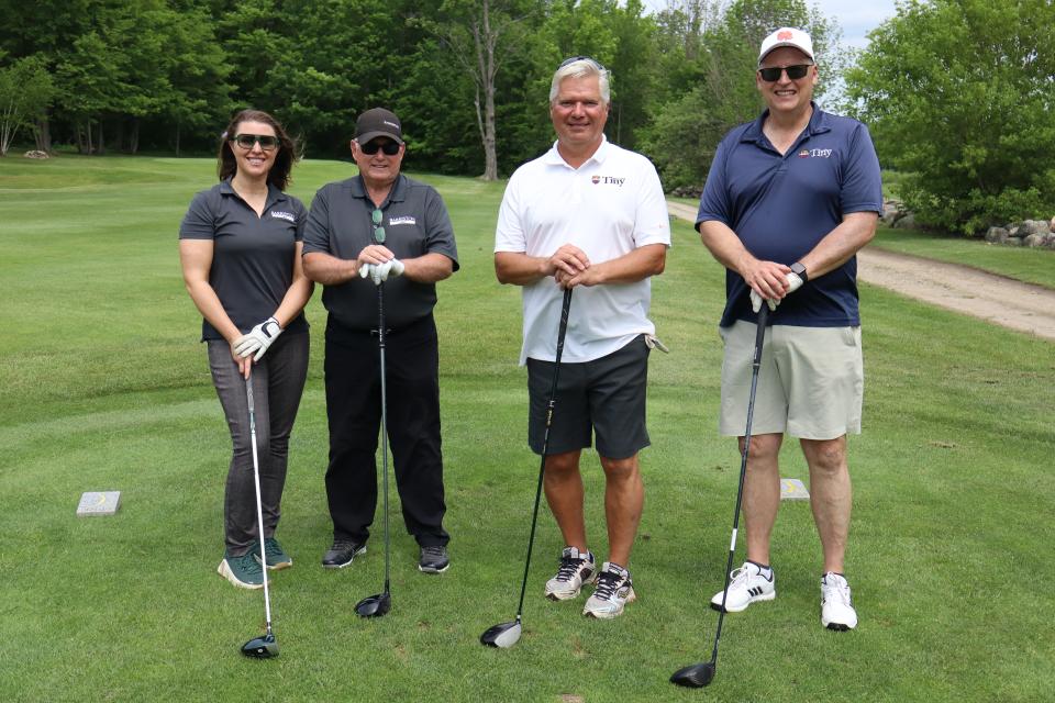 A golf foursome, including Mayor David Evans