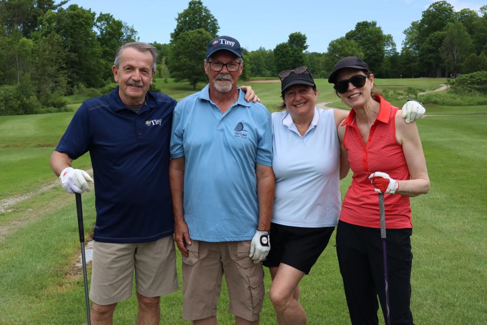 Golf foursome posing together 