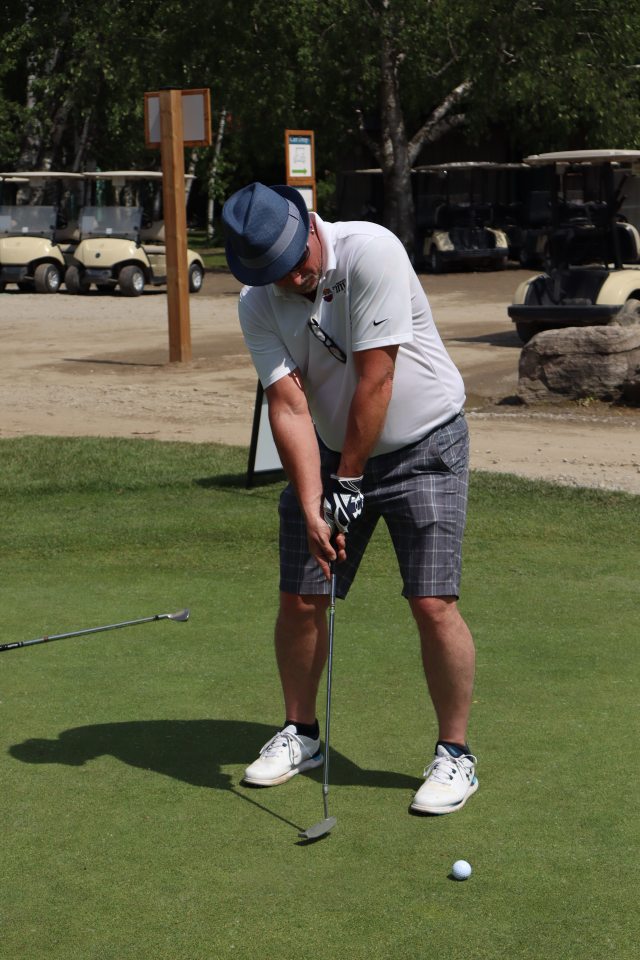  Deputy Mayor Sean Miskimins putting a golf ball on the green