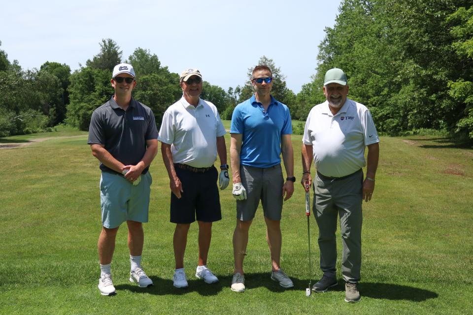 Golf foursome posing together including Councillor Kelly Peter Helowka