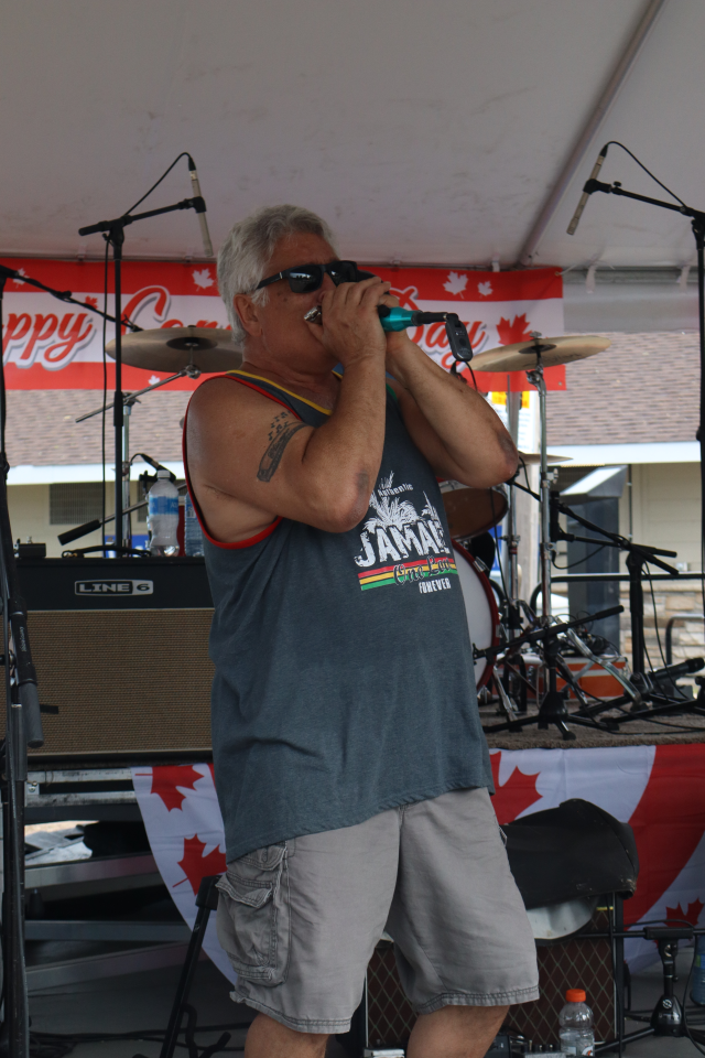 Singer from The Rick Robichaud Band performing on stage.