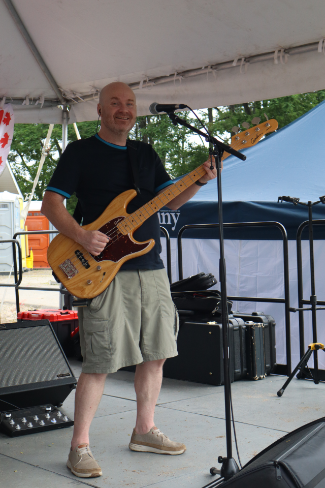 Bassist for The Rick Robichaud Band performing on stage.
