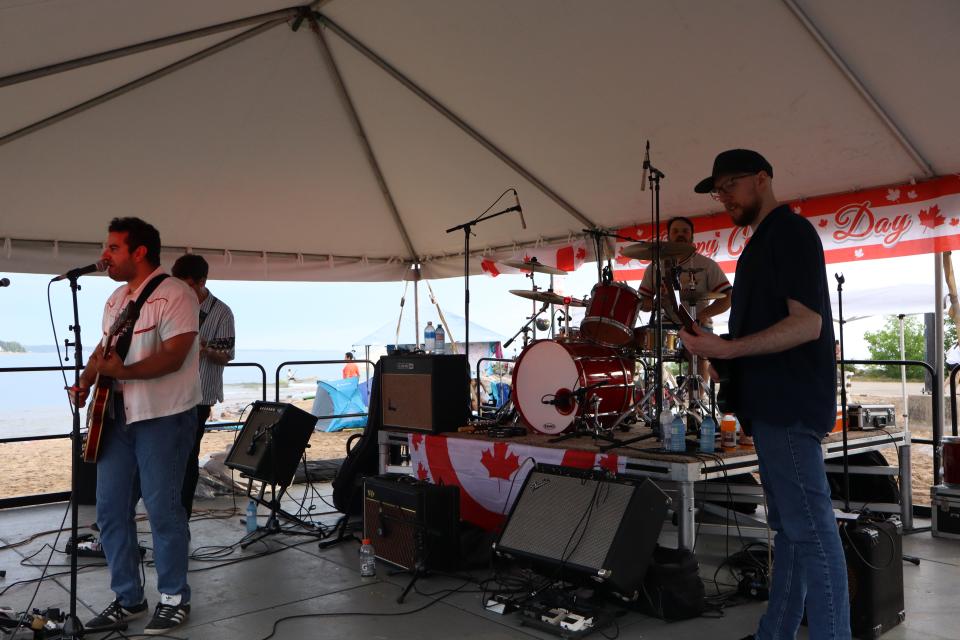 The Lonely Hearts band performing on stage.