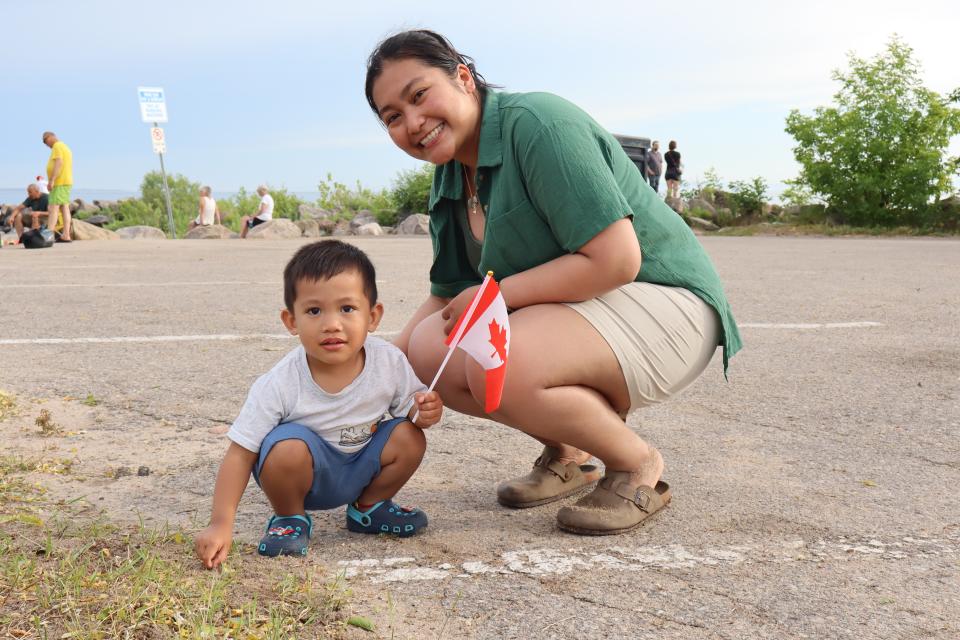 Mom and son holding a Canadian flag at Balm Beach.