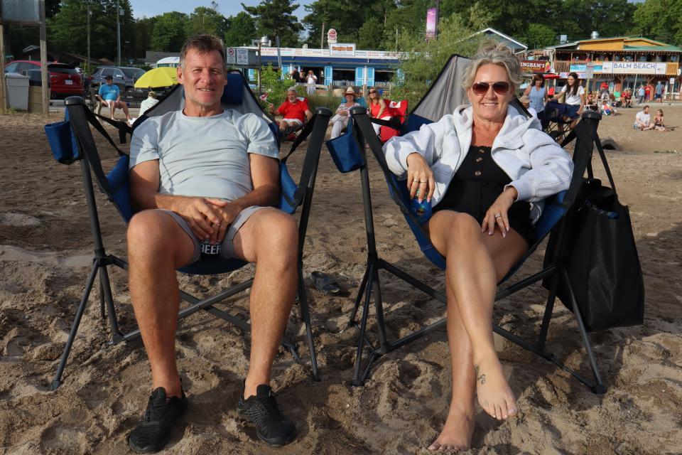 Couple sitting in comfy camping chairs enjoying the live entertainment.