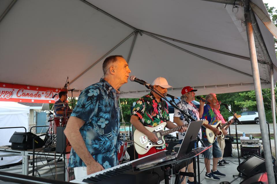The Beach Bums band performing live on stage.