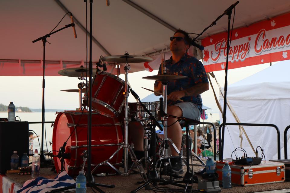 Drummer for the Beach Bums band performing live on stage.
