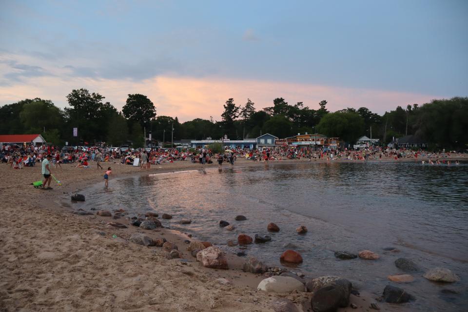 View of a crowded beach on Balm Beach with the sand and water in the foreground.