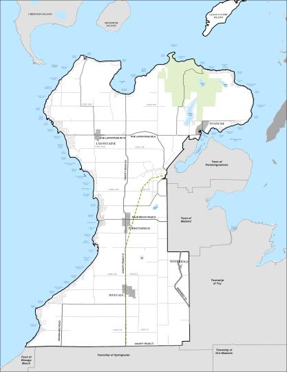 A boundary map of the Township of Tiny in Ontario. The map illustrates the full municipal area, including communities within the township, adjacent municipalities, major roads, and the Georgian Bay shoreline that define the township's geographic extent.