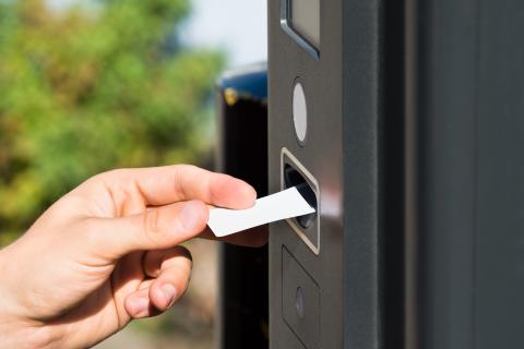 Person obtaining a parking permit from parking machine