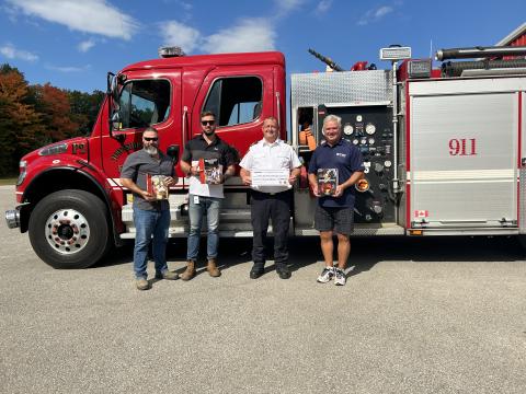 Photo of representatives from Enbridge Gas, Fire Chief Flewelling and Mayor Evans posing in front of a fire truck