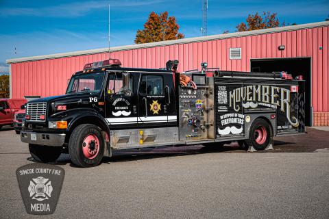 image of Township of Tiny fire truck that has Movember wrap. The truck is parked in front of Station #2, and provided by Simcoe County Fire Media