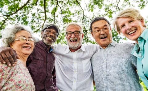 several seniors standing next to one another, with arms wrapped around one another's shoulders