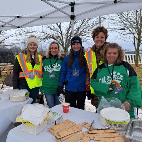 image of several volunteers and staff at the Winter Carnaval d'Hiver pancake table