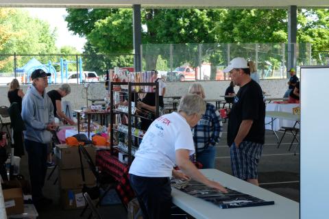 Image of vendors at a previous Community BBQ with customers browsing 
