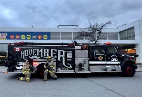 volunteer firefighters posing in front of the decorated Movember truck at Superstore