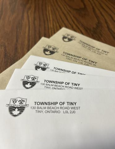 several township of tiny branded envelopes on a wood counter